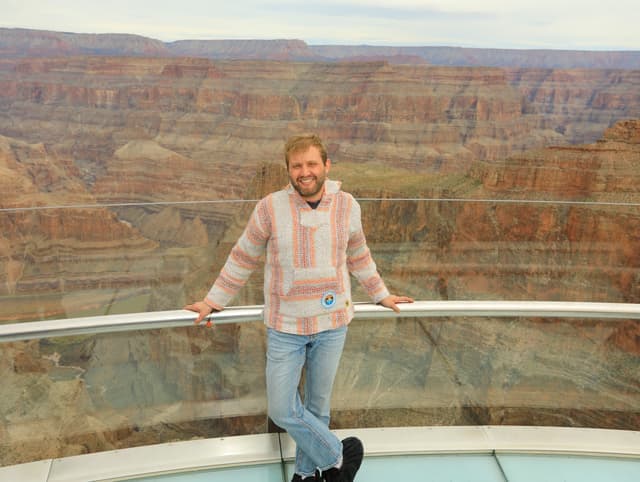 Alejandro Drausal standing in front of the grand canyon